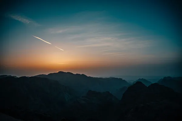 Quelle: Raimond Klavins/Unsplash Silhouette von Bergen mit Lichtstreifen am Himmel