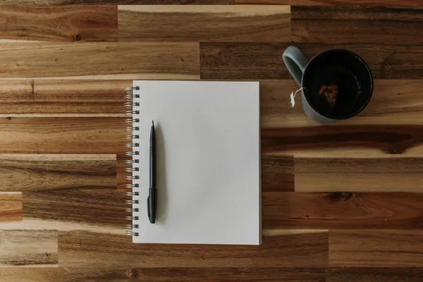 Quelle: Kelly Sikkema/Unsplash Notizblock, Stift und Tasse auf Holztisch